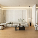 Modern living room with a white sofa, coffee table, and decorative items.